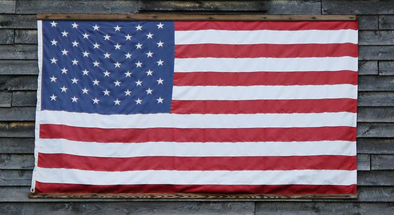 american flag hung on wooden sided building