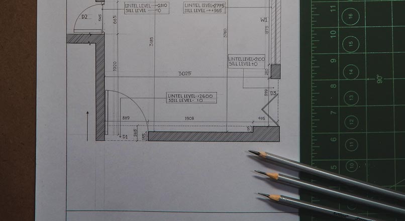 building plans with pencils